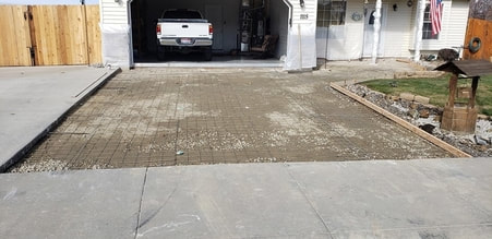 new concrete slab being poured to replace an old broken driveway, the concrete is removed and ready to be poured