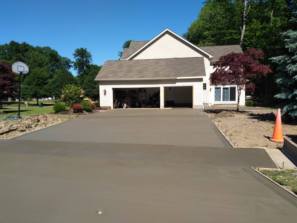 A brand new driveway leading to a beautiful single story home